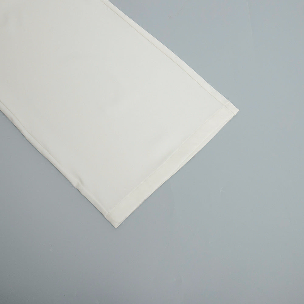 High-Waist Pleated Wide-Leg Trousers in White — close-up of hem