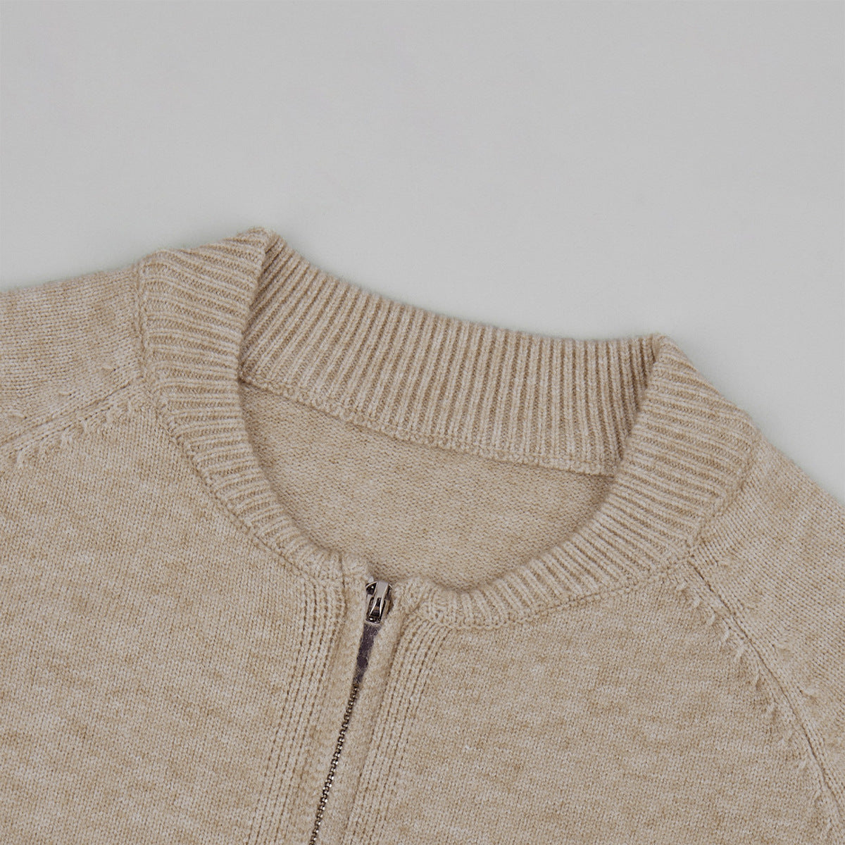 Three-Piece Knit Set: Zip-Up Cardigan, Sleeveless Top & Wide-Leg Pants in Oat — close-up of the collar and zipper