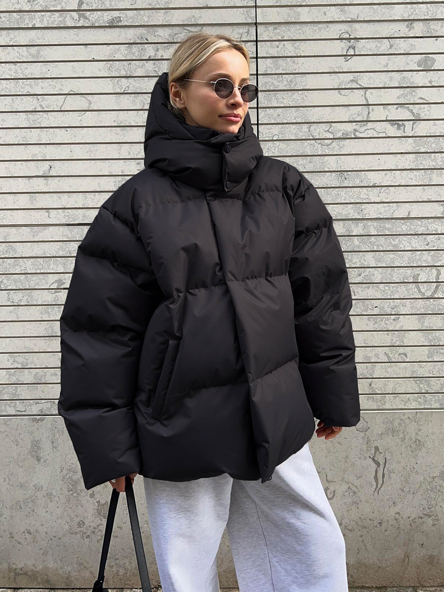 Matte Oversized Hooded Puffer Jacket in Black — front view on model
