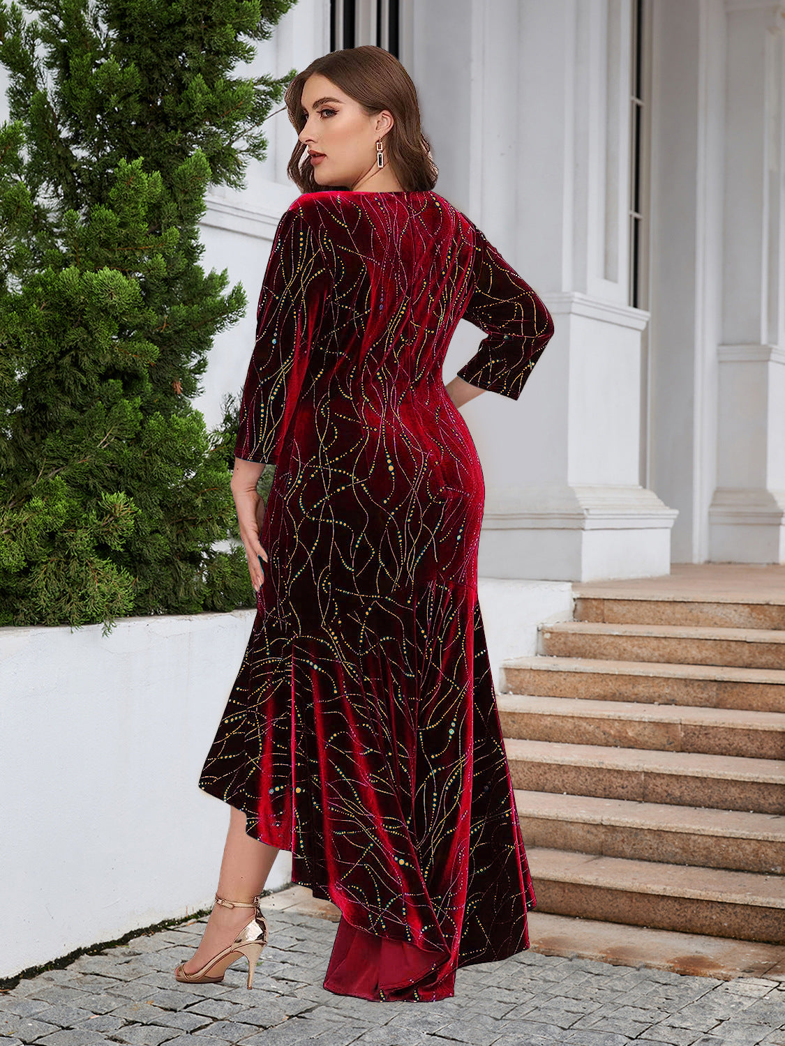 Plus-Size Velvet Mermaid Dress with High-Low Hem in Red — side view on model