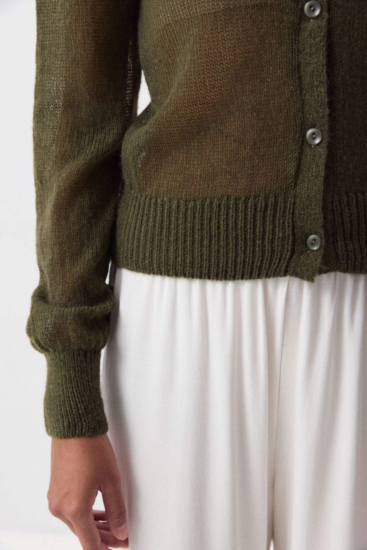 Airy Button-Front Knit Cardigan in Olive — close-up of the button placket and ribbed hem