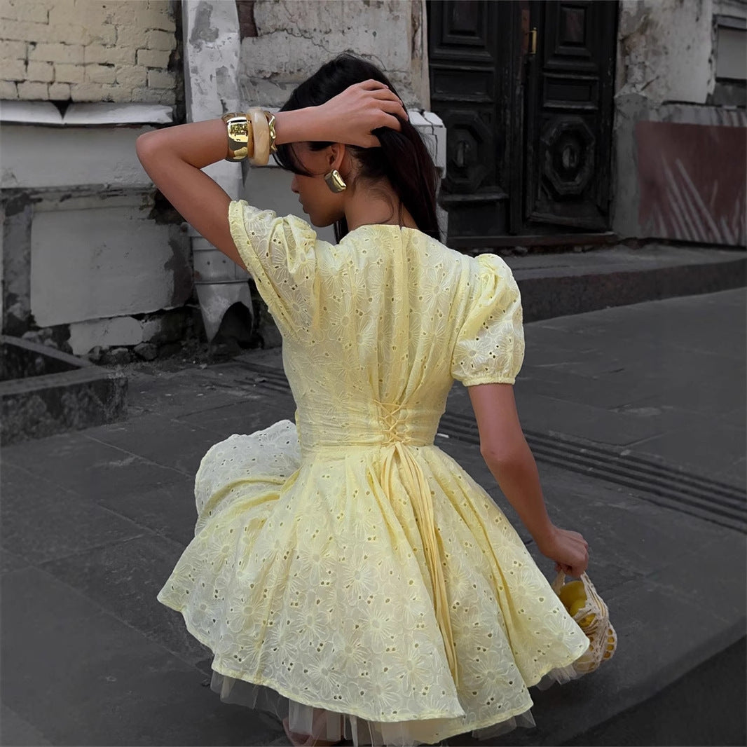 Yellow Eyelet Puff-Sleeve Mini Dress in Pale Yellow — back view on model