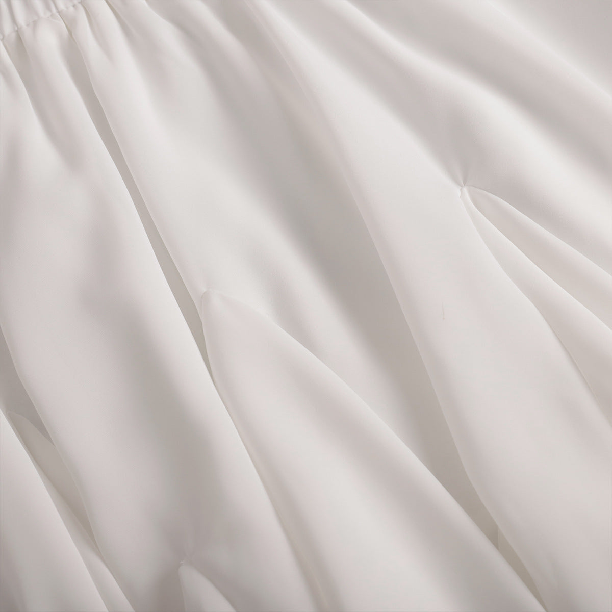 Pleated Bubble Mini Skirt in White — close-up of elastic waistband