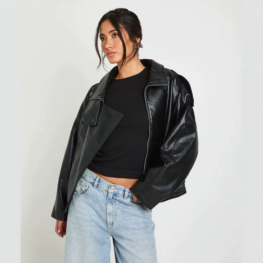 Oversized Stand-Collar Faux Leather Jacket in Black — front view on model