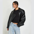 Oversized Stand-Collar Faux Leather Jacket in Black — front view on model
