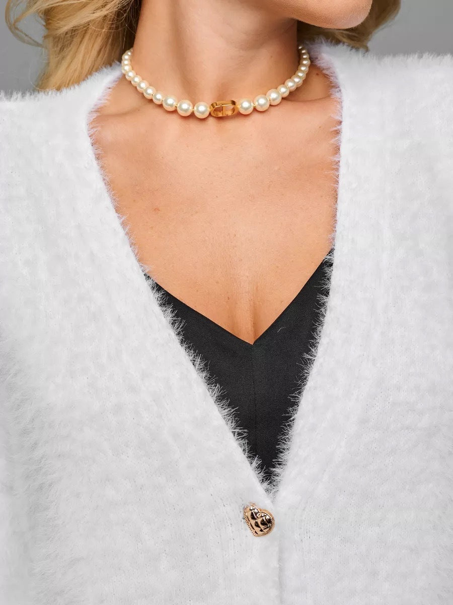 Fuzzy V-Neck Cardigan with Heart Buttons in White — close-up of the V-neck