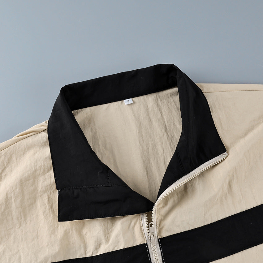 Contrast-Stripe Stand-Collar Track Jacket in Stone — close-up of the black-lined stand collar