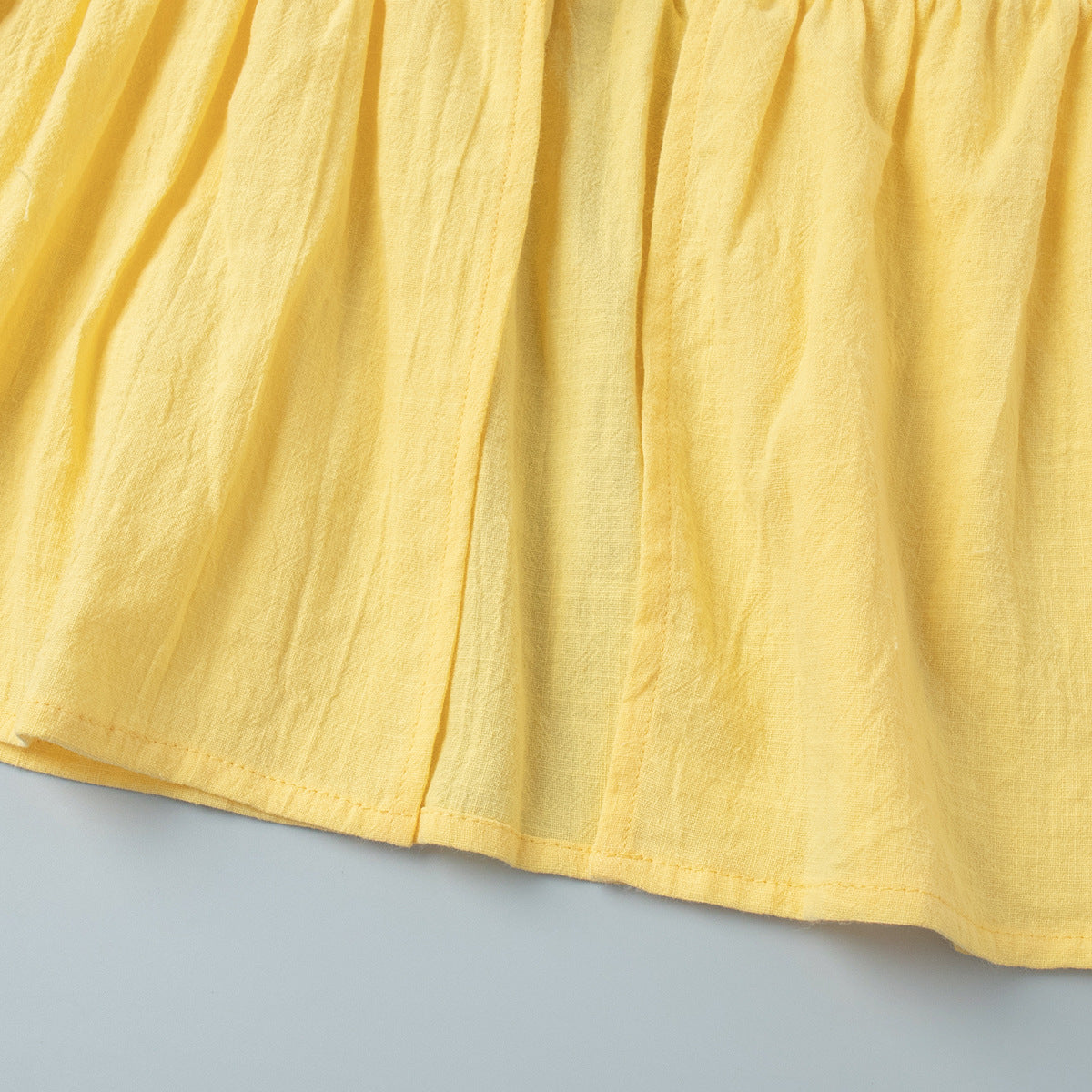 Tie-Front Puff-Sleeve Top & Maxi Skirt Set in Butter Yellow — close-up of the skirt waistband