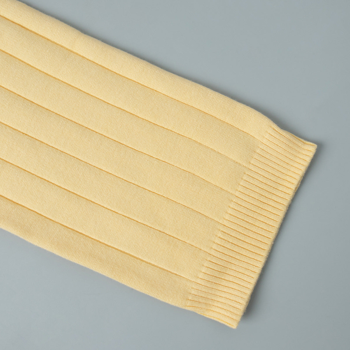 Oversized Wide-Rib Crew Neck Button Cardigan in Butter Yellow — close-up of the ribbed cuff