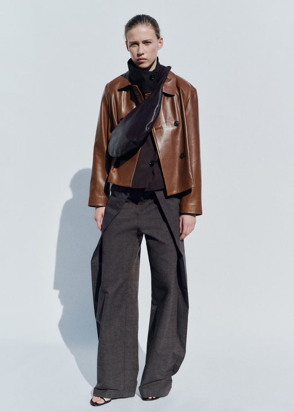 Cropped Double-Breasted Faux Leather Jacket in Cognac — full-length view on model