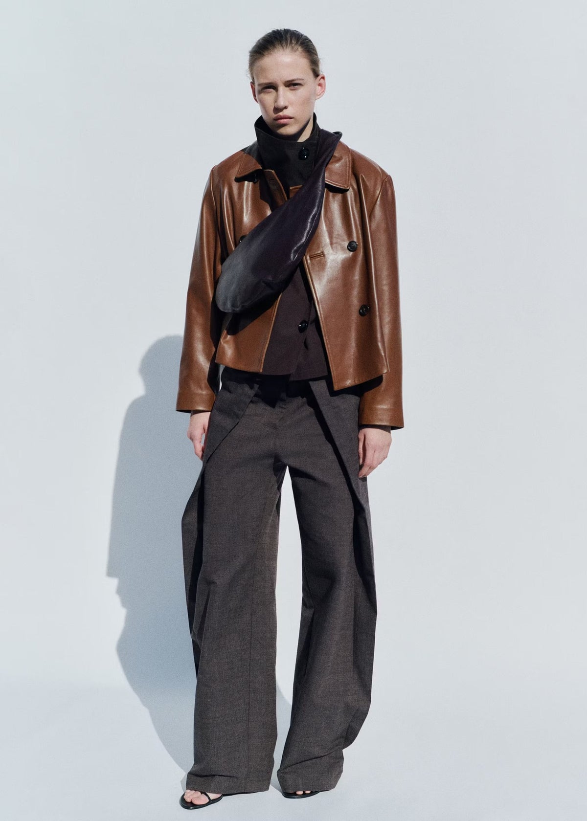 Cropped Double-Breasted Faux Leather Jacket in Cognac — full-length view on model
