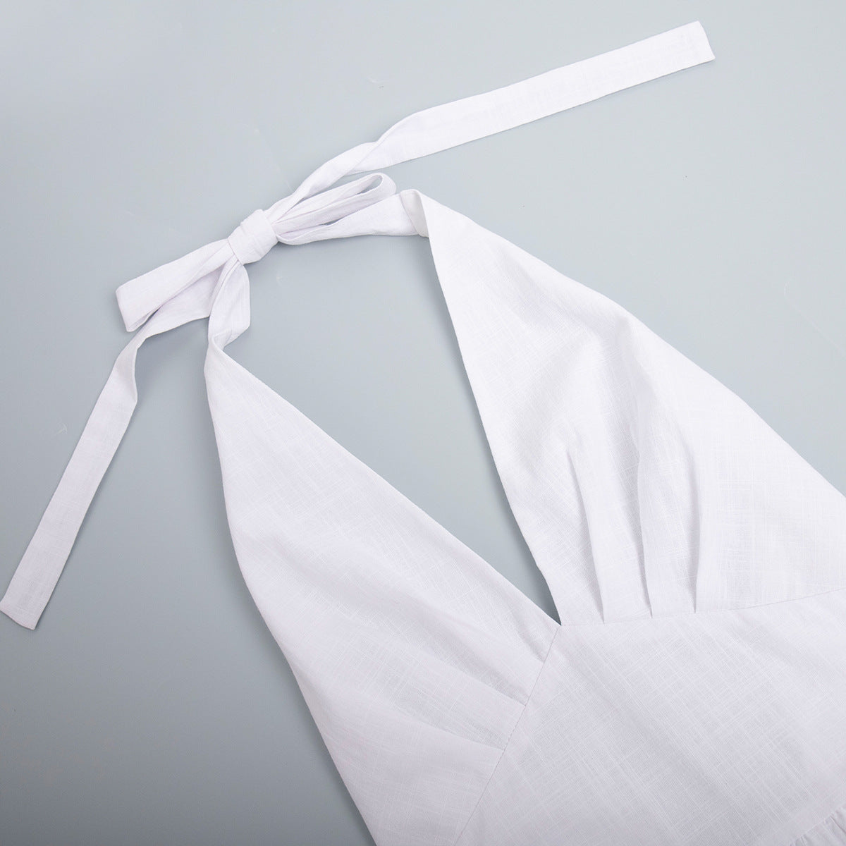 Cotton Halter V-Neck Maxi Dress in White — close-up of the halter tie