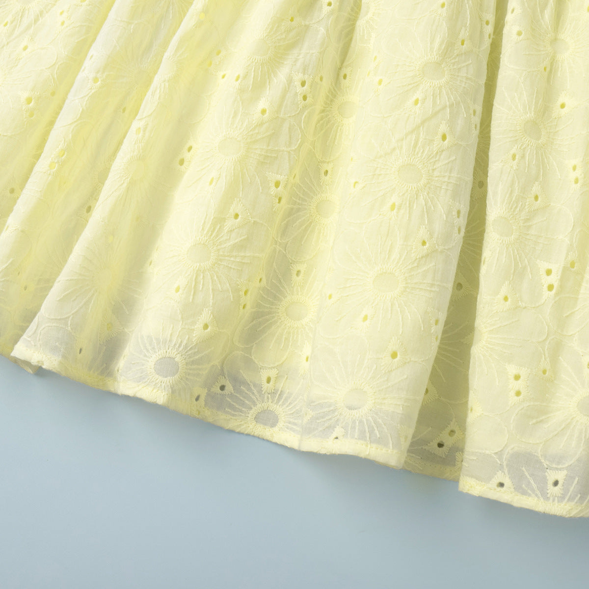 Yellow Eyelet Puff-Sleeve Mini Dress in Pale Yellow — close-up of the eyelet hem
