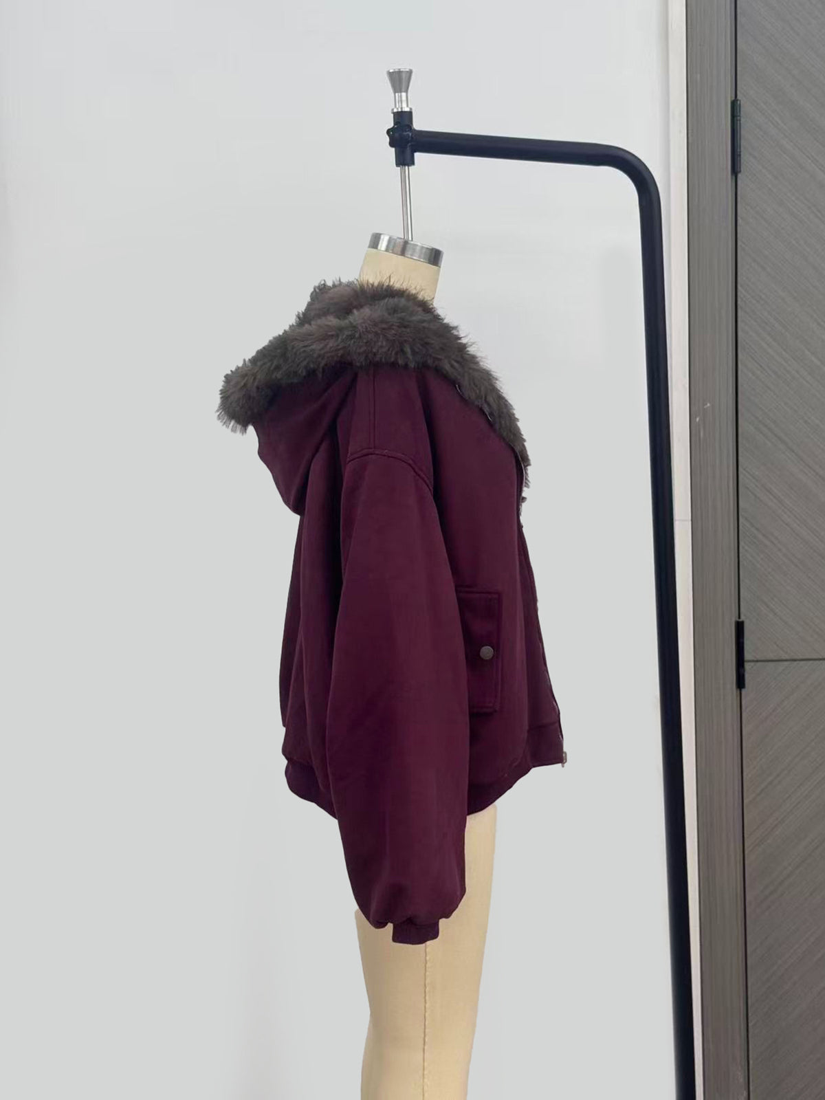 Reversible Faux Fur Hooded Jacket with Suede-Look Shell in Burgundy — side view on a dress form