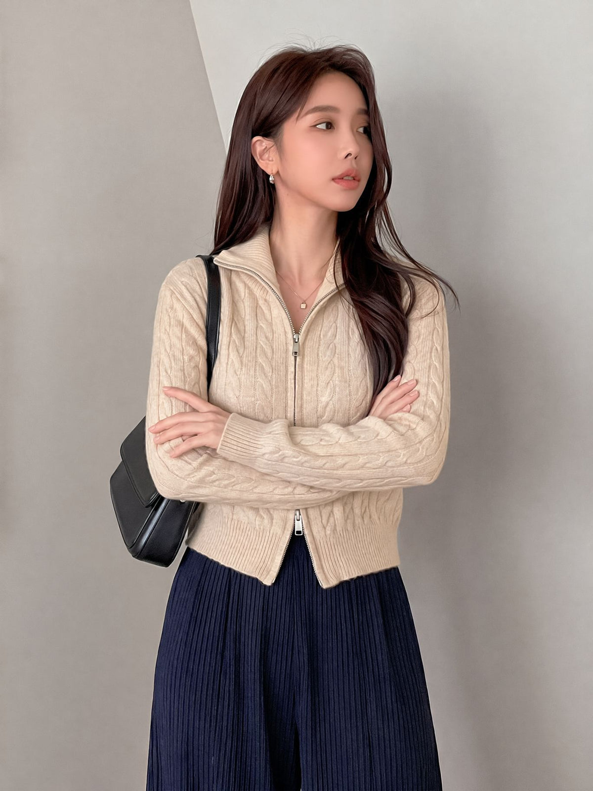 Cable-Knit Zip-Up Cardigan Sweater in Ivory — front view on model