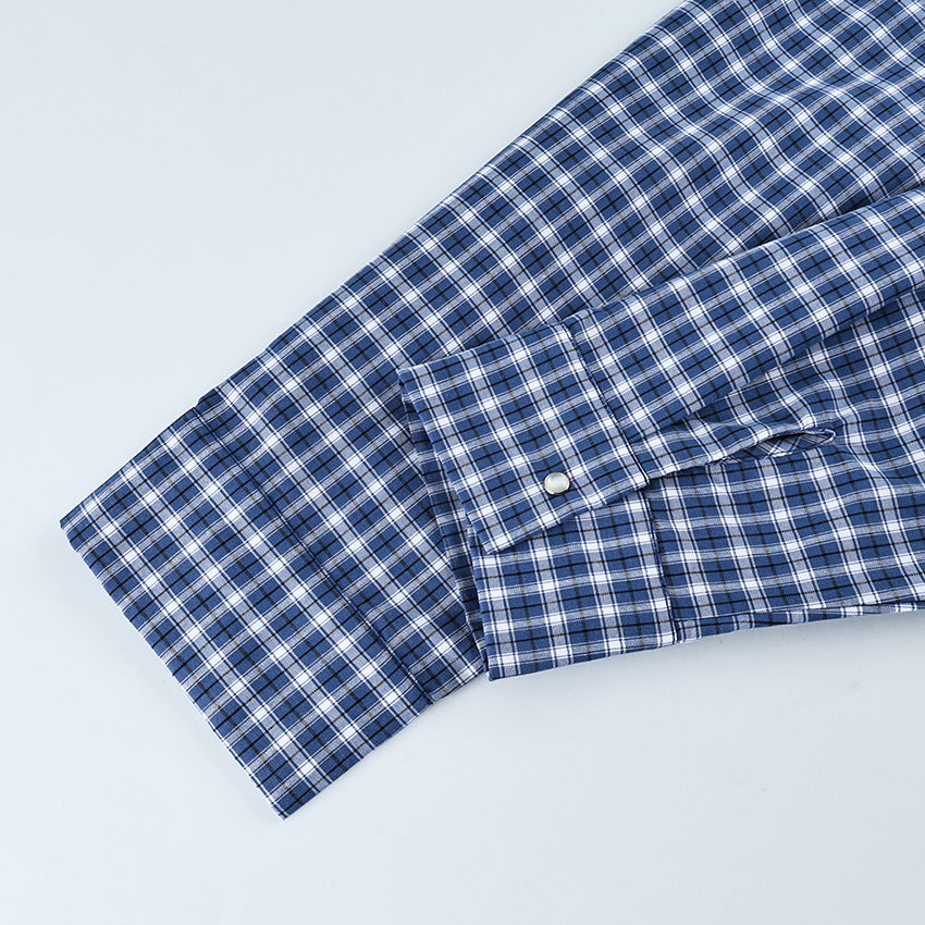Oversized Cotton Plaid Button-Up Shirt in Navy Plaid — close-up of the buttoned cuff