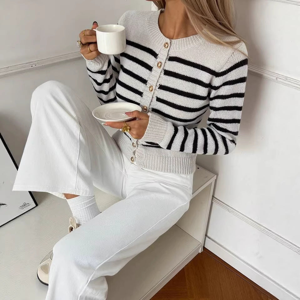 Striped Crew-Neck Cardigan with Gold Buttons in Cream & Black — on model, seated