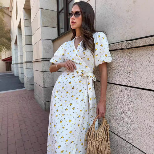 Cotton Floral Puff-Sleeve Wrap Midi Dress in Yellow Floral — walking view on model