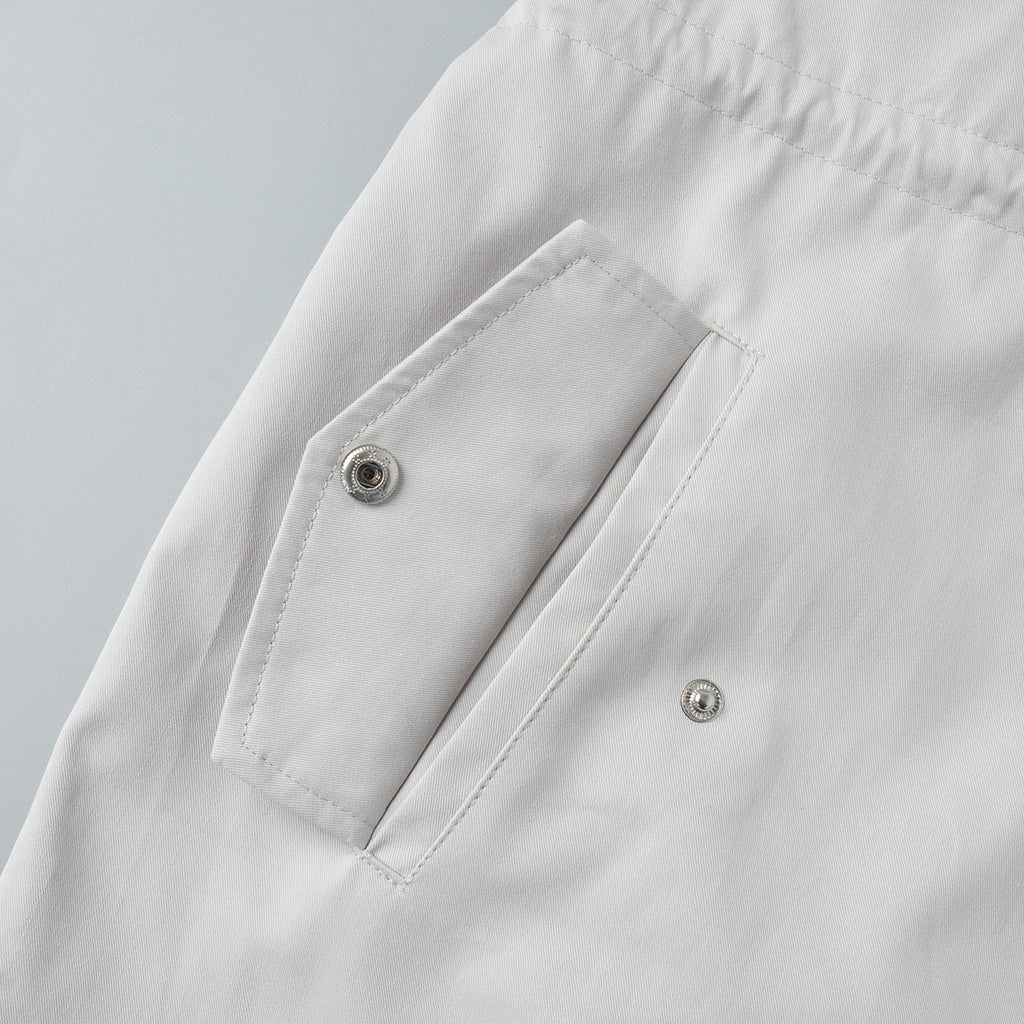 Cotton Drawstring Waist Jacket with Stand Collar in Off-White — close-up of flap pocket