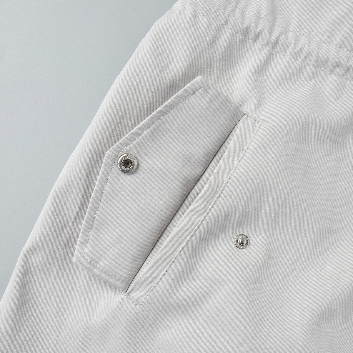 Cotton Drawstring Waist Jacket with Stand Collar in Off-White — close-up of flap pocket