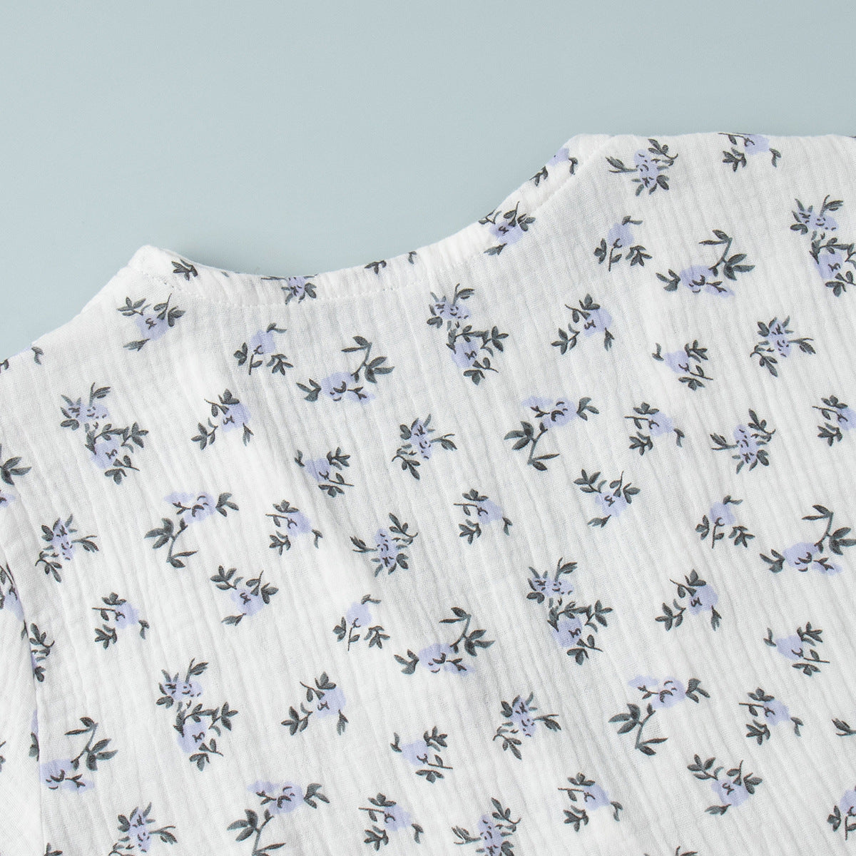 Cotton Puff-Sleeve Wrap Midi Dress in Blue Floral — close-up of the wrap tie