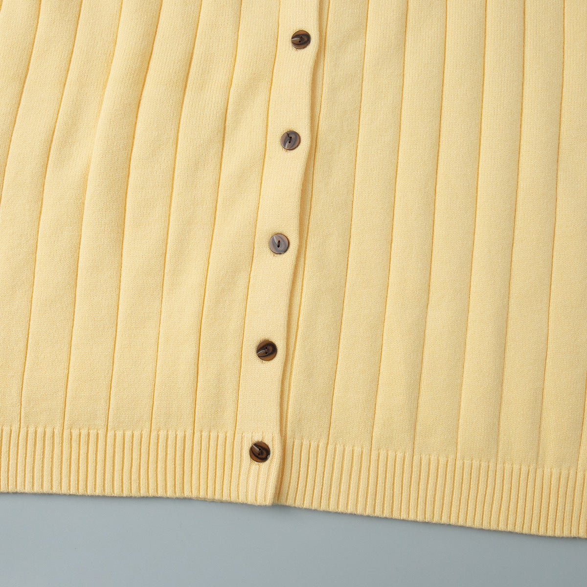 Oversized Wide-Rib Crew Neck Button Cardigan in Butter Yellow — close-up of the buttons and hem