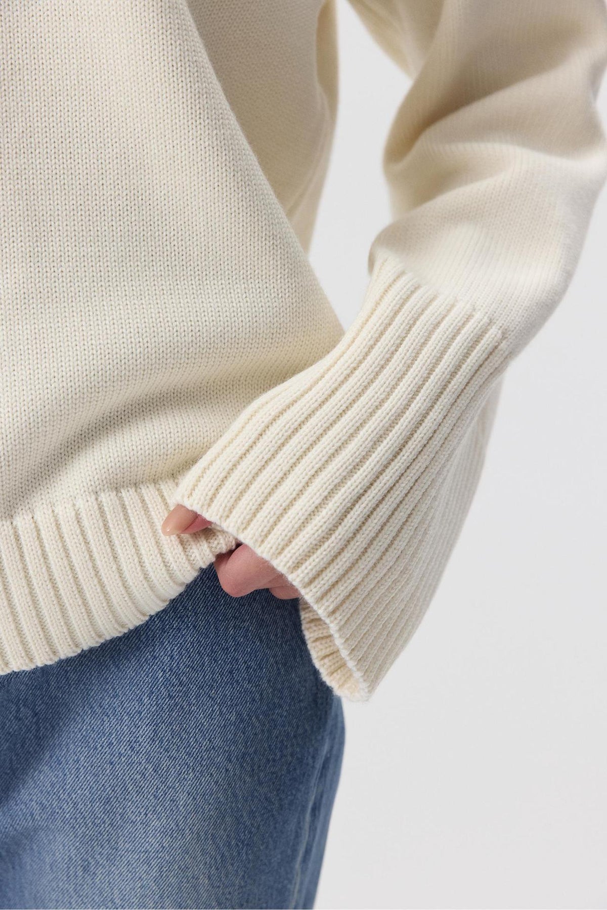 Relaxed Cotton Crew Neck Sweater with Ribbed Cuffs in Ivory — close-up of the ribbed cuff