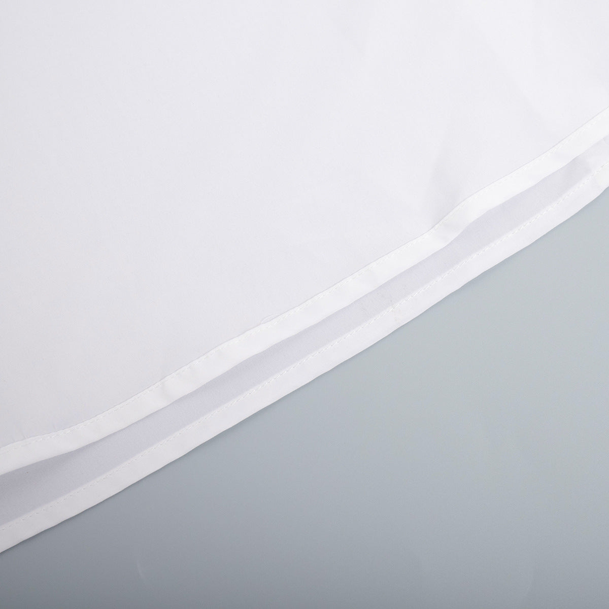Cotton Halter V-Neck Maxi Dress in White — close-up of the hem