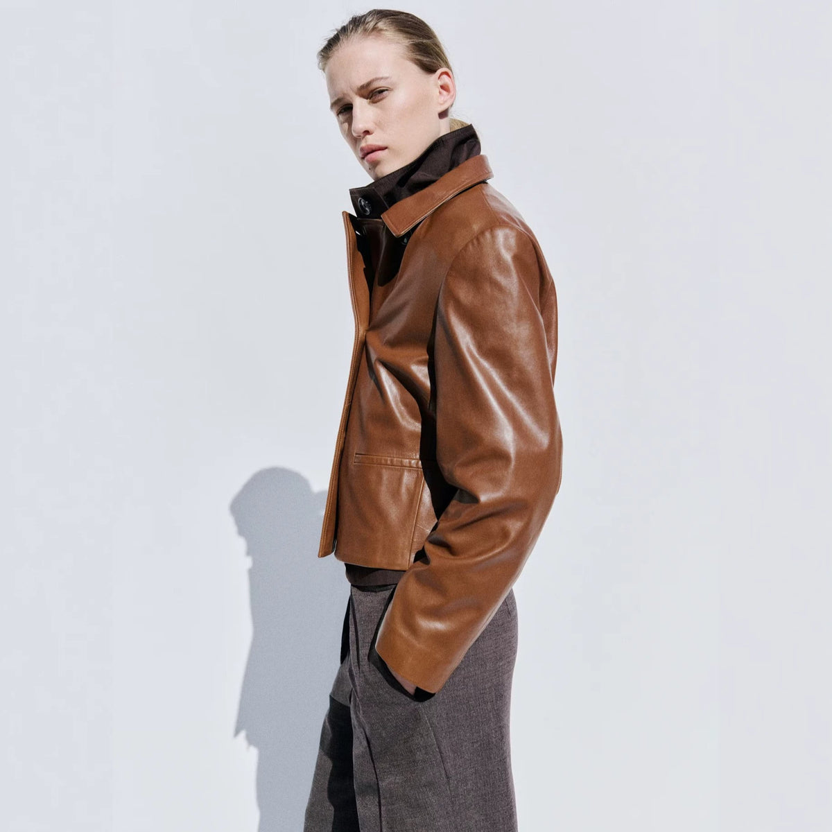 Cropped Double-Breasted Faux Leather Jacket in Cognac — on model with wide-leg trousers