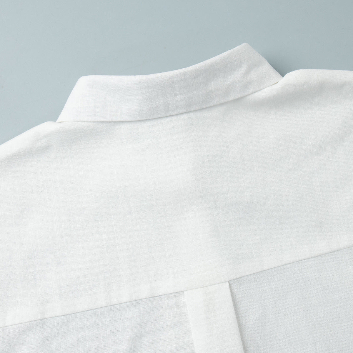 Tie-Front Cotton Mini Shirt Dress in White — close-up of the pointed collar