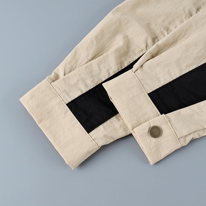 Contrast-Stripe Stand-Collar Track Jacket in Stone — close-up of the snap cuff