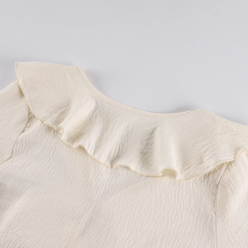 Ruffle Tie-Front Blouse and Wide-Leg Pants Set in Cream — close-up of the ruffle collar