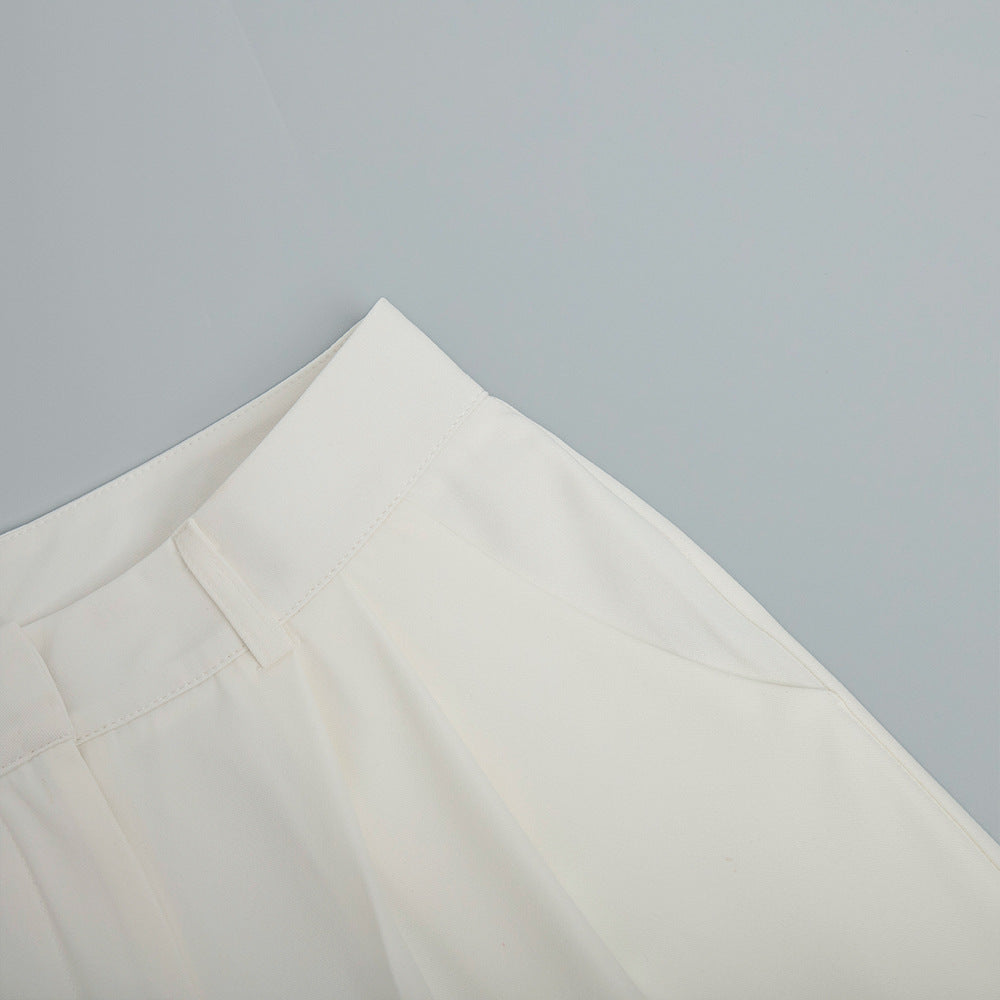High-Waist Pleated Wide-Leg Trousers in White — close-up of fabric and hem