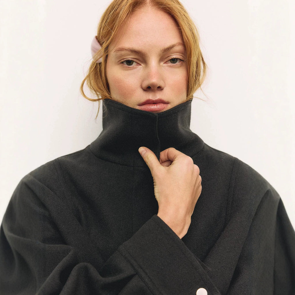 Funnel Neck Wool-Look Jacket with Buckle Hem Strap in Black — close-up of the funnel neck on model
