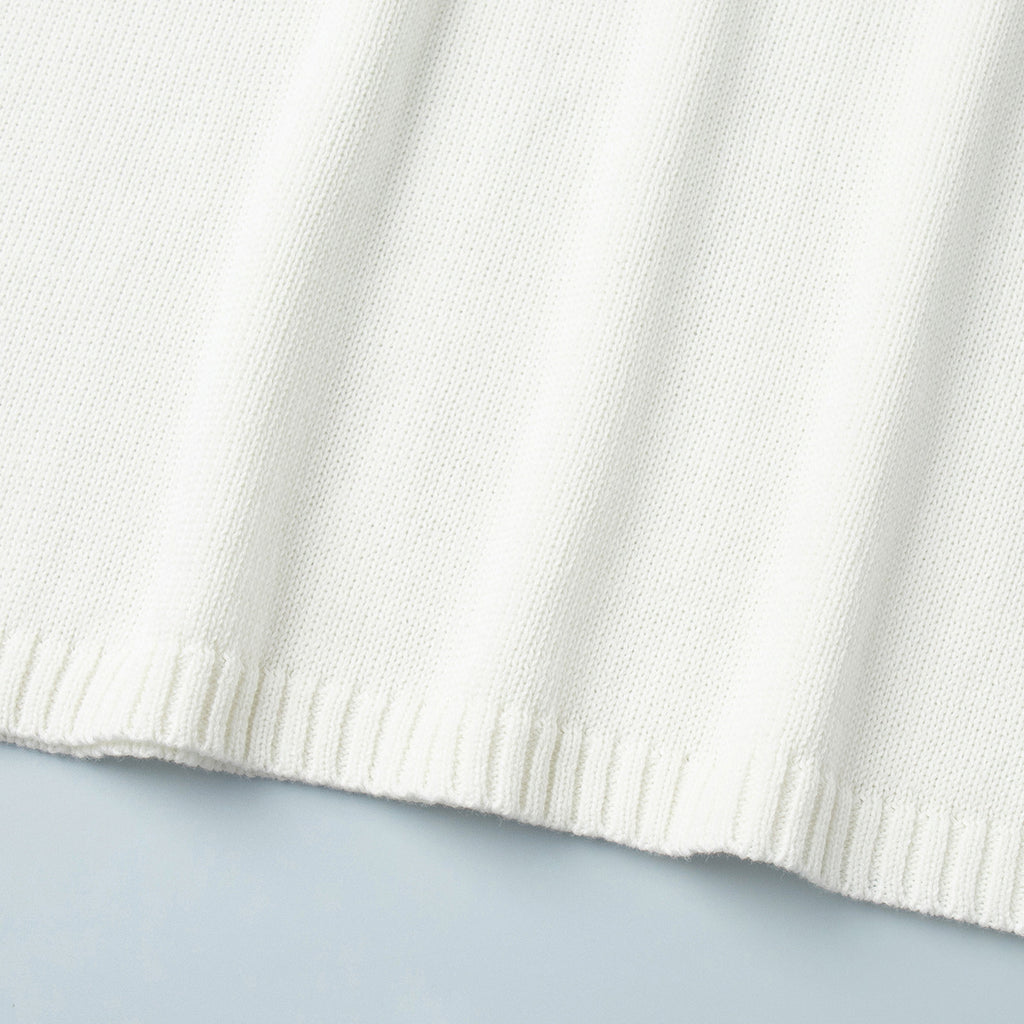 Oversized Open-Back Cotton Knit Sweater in Cream — close-up of the ribbed hem