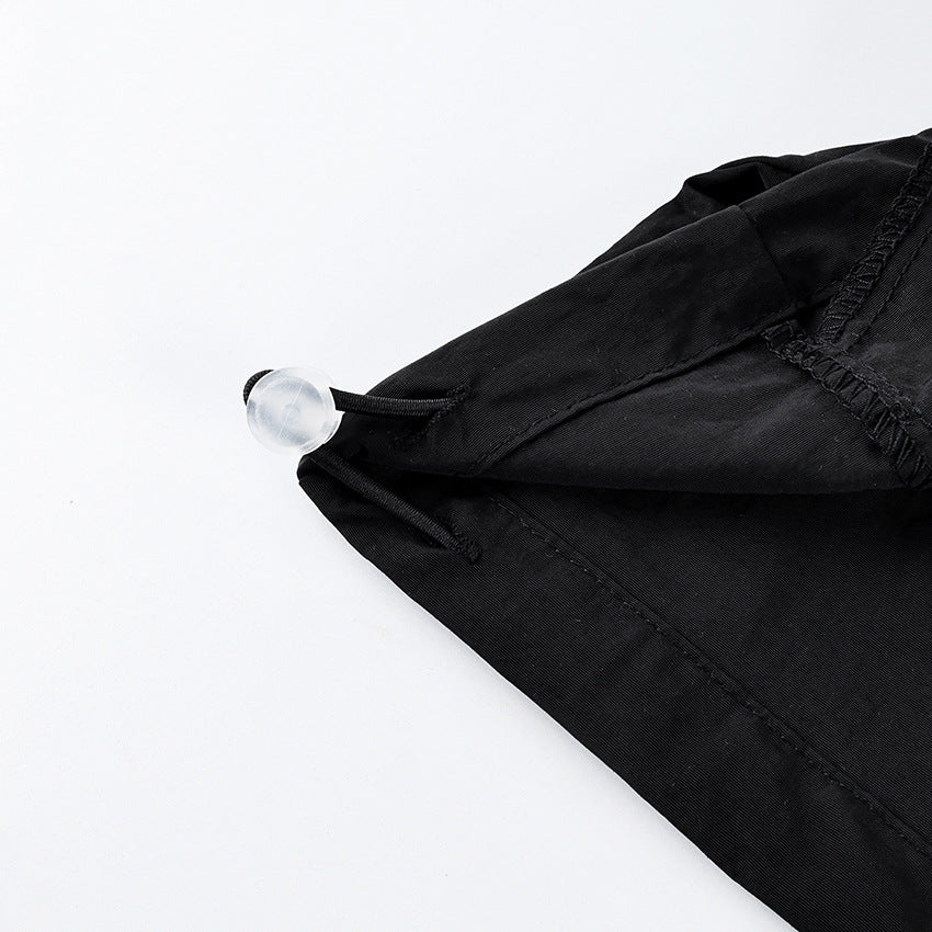 Oversized Stand-Collar Nylon Jacket with Drawcord Hem in Black — close-up of the drawcord toggle at the hem