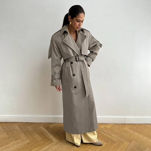 Classic Long Double-Breasted Cotton Trench Coat in Greige — belted, front view on model, full length