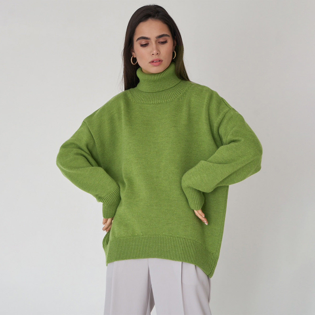 Oversized Knit Turtleneck Sweater in Apple Green — front view on model