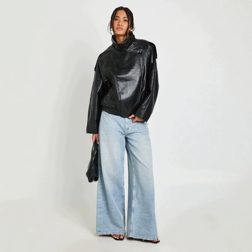 Oversized Stand-Collar Faux Leather Jacket in Black — full-length view on model with jeans