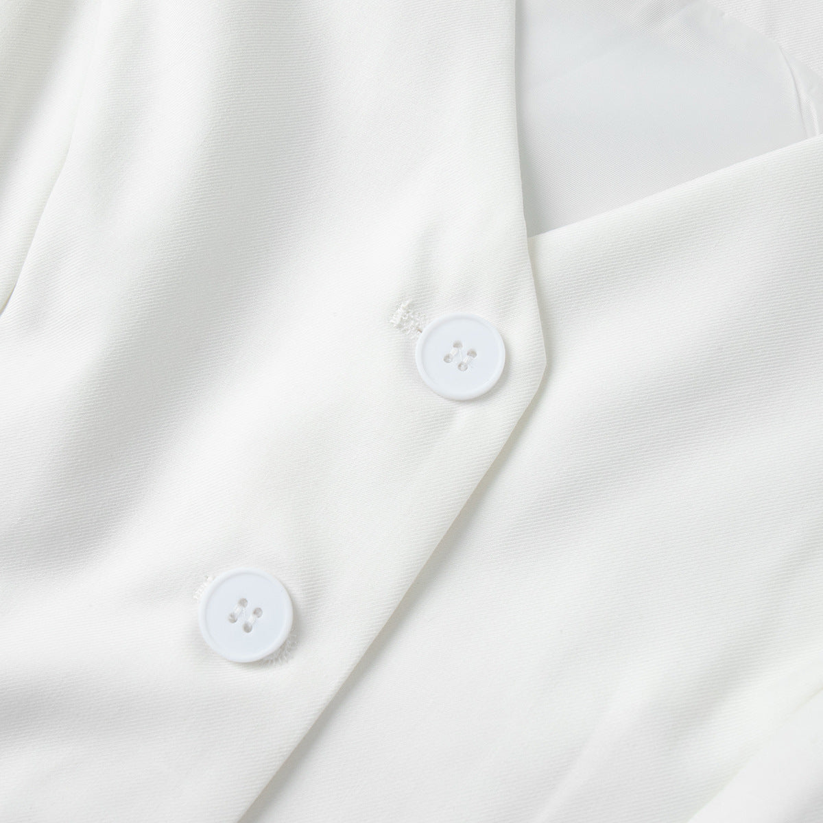 V-Neck Vest & Pleated Shorts Set in White — close-up of the vest buttons