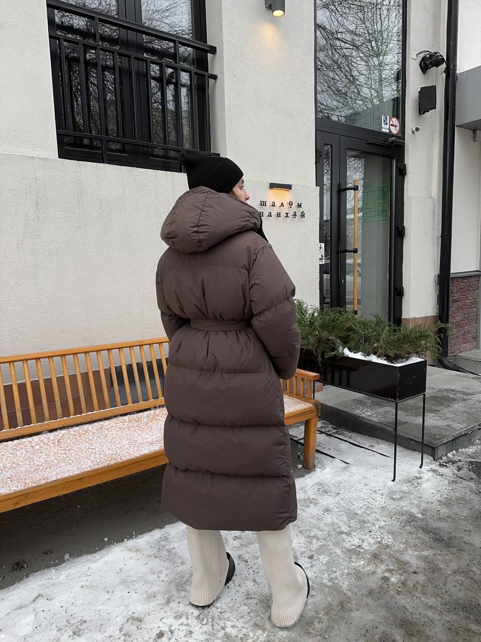 Long Hooded Puffer Coat with Tie Belt in Chocolate — back view
