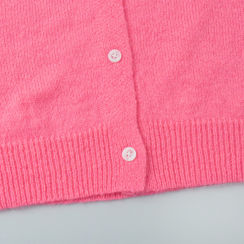 Soft Fuzzy Crew Neck Button Cardigan in Hot Pink — close-up of the ribbed hem