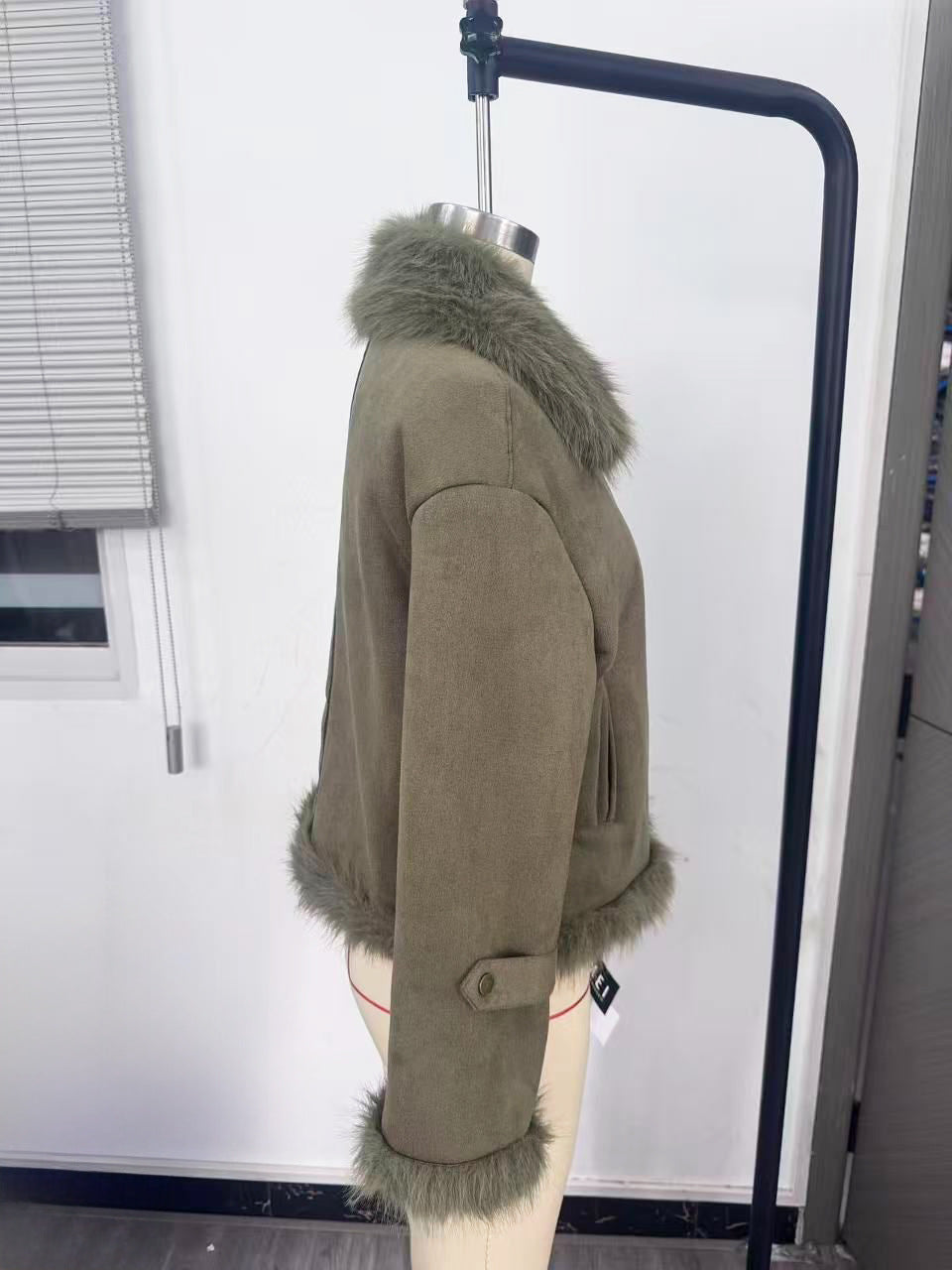 Cropped Faux Suede Shearling Jacket with Faux Fur Collar in Olive — side view on a dress form