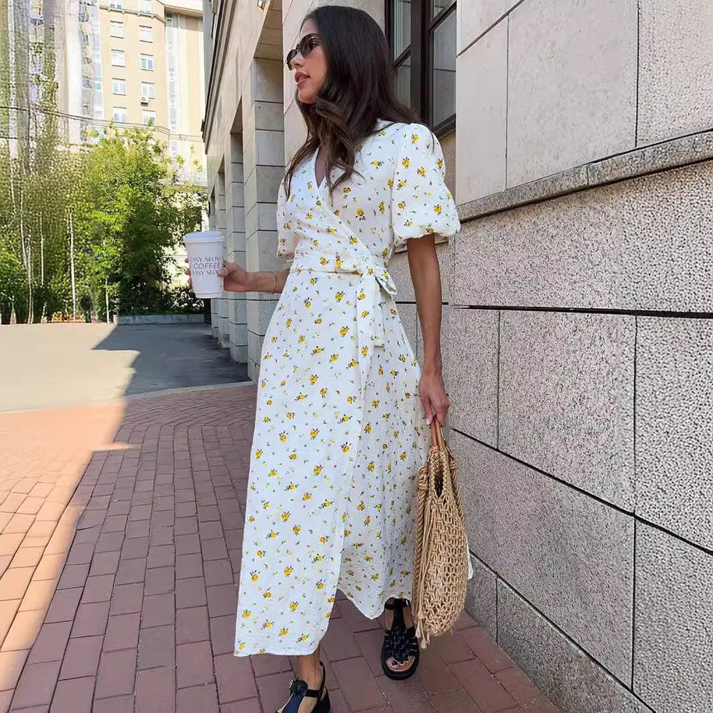 Cotton Floral Puff-Sleeve Wrap Midi Dress in Yellow Floral — three-quarter view on model