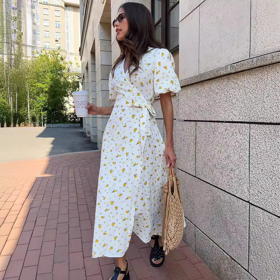 Cotton Floral Puff-Sleeve Wrap Midi Dress in Yellow Floral — three-quarter view on model