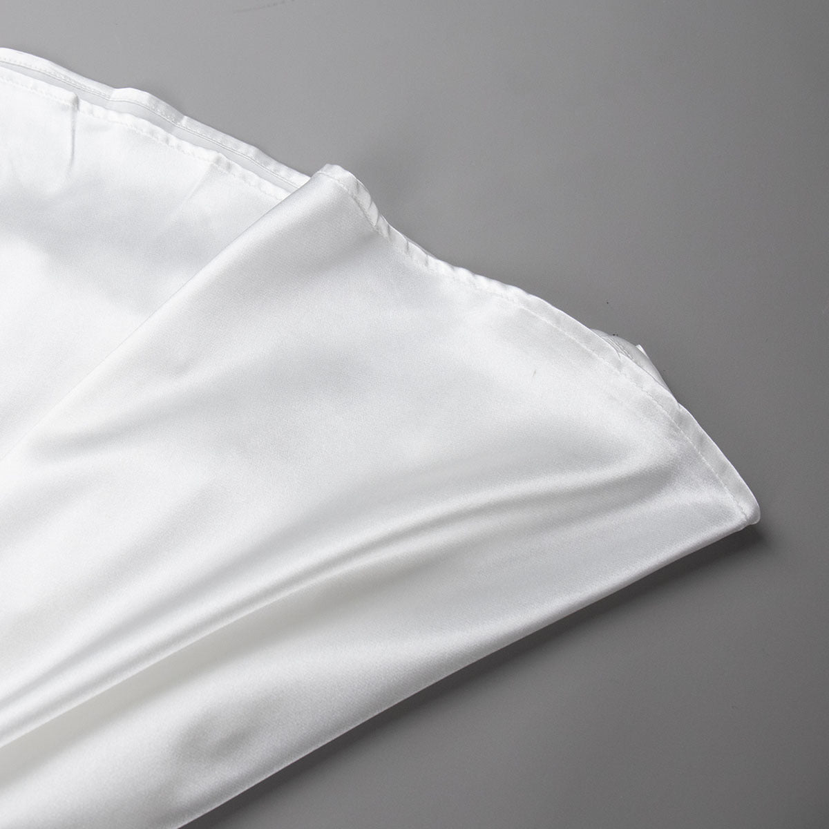 Satin A-Line Midi Skirt with Elastic Waist in Ivory White — close-up of satin hem