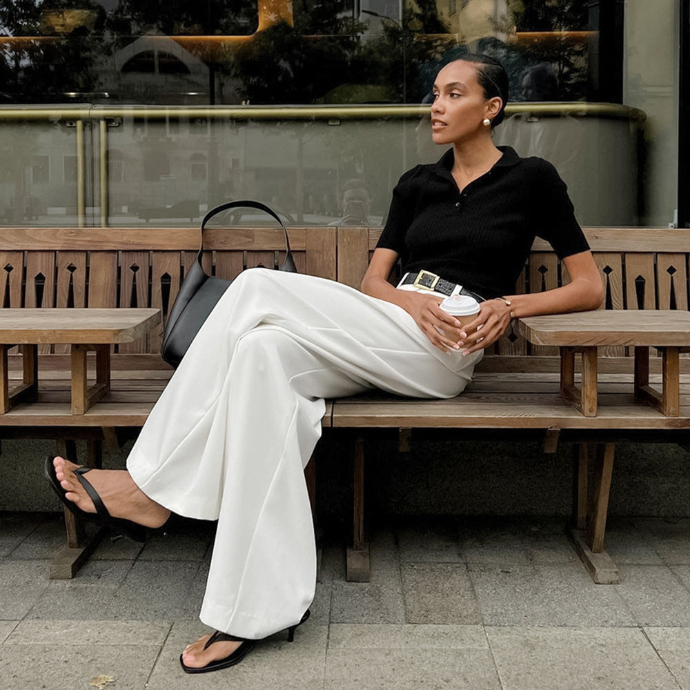 High-Waist Pleated Wide-Leg Trousers in White — on model, walking