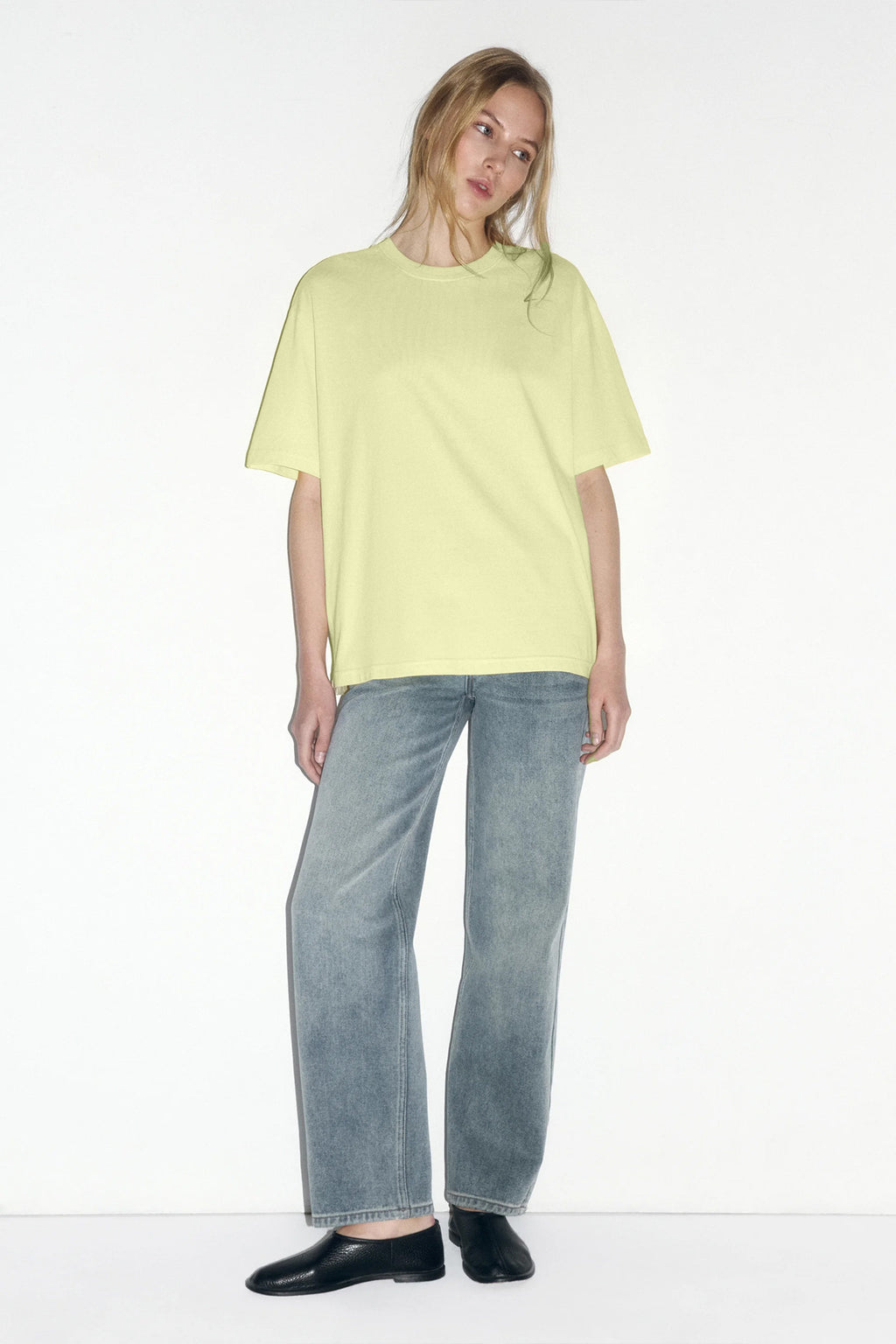 Relaxed Cotton Crew-Neck Tee in Butter Yellow — full-length view on model with jeans