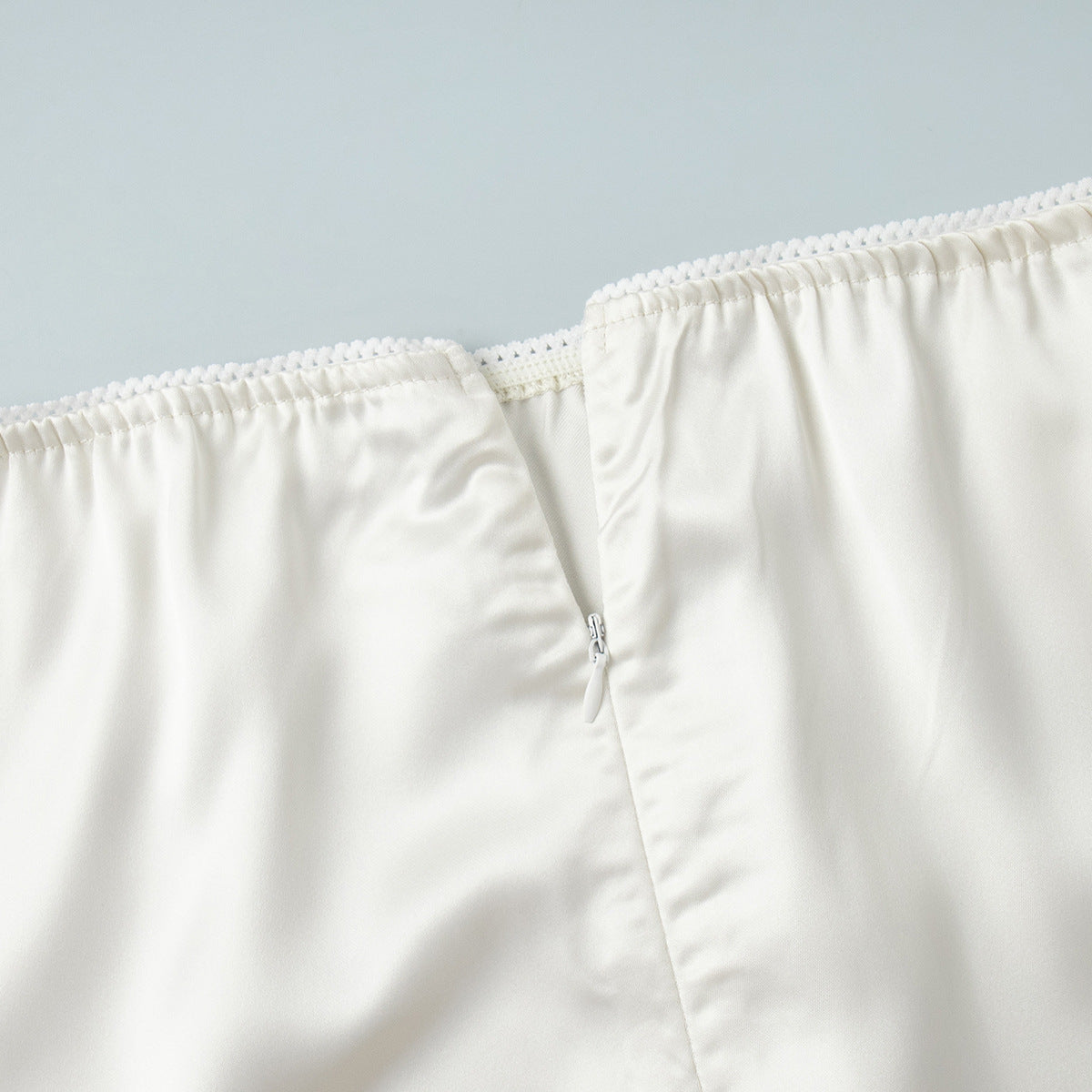 Satin Midi Skirt with Lace Hem in Ivory — close-up of waistband lace edge