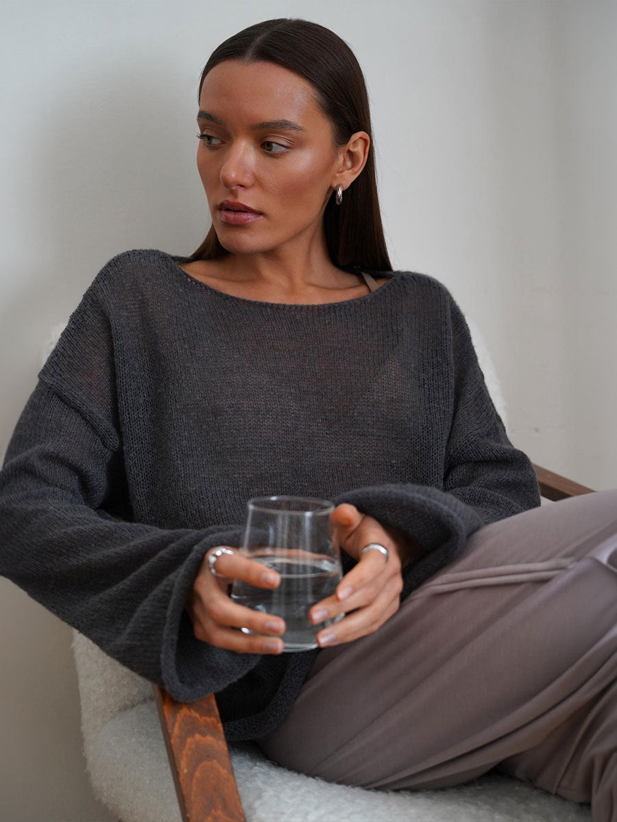 Sheer Open-Knit Bell Sleeve Sweater in Charcoal — seated on model